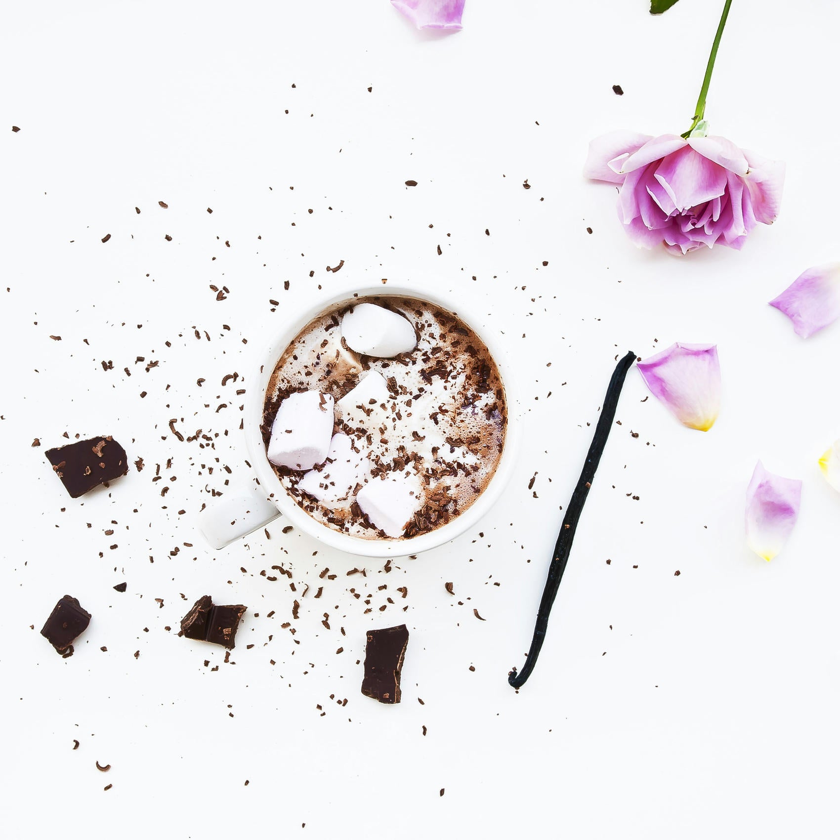 mug of hot chocolate surrounded by flower petals