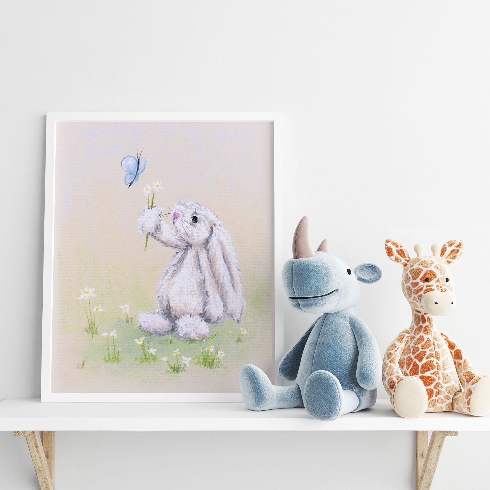 Adorable white rabbit holding a bouquet of daisy flowers to a butterfly, framed art print on shelf with soft toys