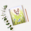 Cute brown rabbit peeping over the meadow flowers, artwork design spiral bound, vegan-friendly, notebook