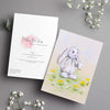 Adorable white rabbit blowing dandelion seeds, artwork greeting card. Front and back view