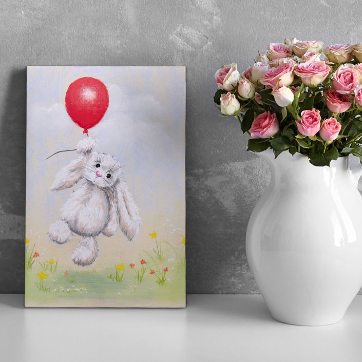 White rabbit floating above delicate flowers holding a red balloon, artwork, eco-friendly canvas print