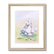 Cute rabbit and flowers wall art in a natural frame with white mount.