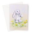 Adorable white rabbit blowing dandelion seeds, artwork greeting card. Portrait format