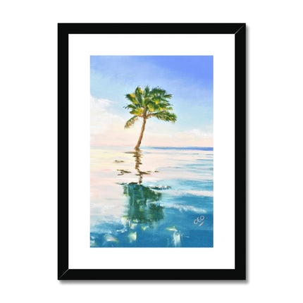 Palm tree set against blue sky and reflecting in clear turquoise water. Fine art print in a black frame with a white mount. Portrait format.