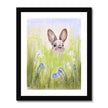 Rabbit in the meadow flowers fine art print with a white border in a black frame.