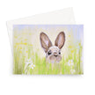 Cute brown rabbit peeping over the meadow flowers artwork greeting card. Landscape format