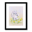 White rabbit and dandelion seeds nursery art print in black frame with white mount.