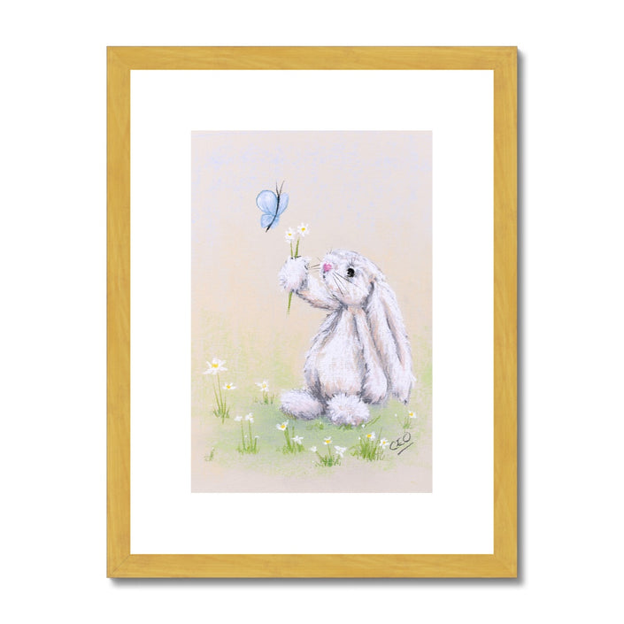 Adorable rabbit, flowers and butterfly nursery art print in gold frame with white mount.