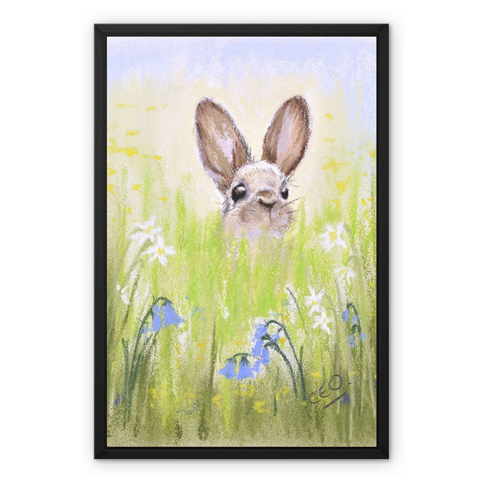 Brown Rabbit peeping over the meadow flowers canvas artwork print with black picture frame. Ready to hang