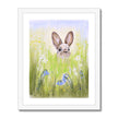 Brown rabbit in the meadow flowers nursery art print with a white border in a white frame.