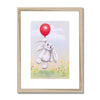 Rabbit and balloon nursery fine art print in natural frame with white mount.