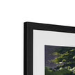 Illuminated, framed fine art print. Close up of top corner and black frame.