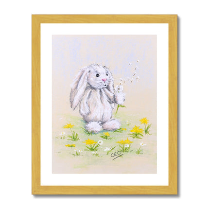 Rabbit and dandelions wall art print in a gold frame. 