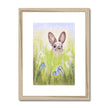 Rabbit in the meadow flowers. Fine art print with natural light wooden frame and a white mount.