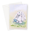 Adorable white rabbit watering the daisies with a little blue watering can, art greeting card. Portrait format