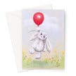 Adorable white rabbit floating above delicate flowers from a balloon, artwork greeting card. Portrait orientation