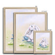 White fluffy rabbit watering the daisies with a little blue watering can, nursery art prints in a natural frame. Different sizes